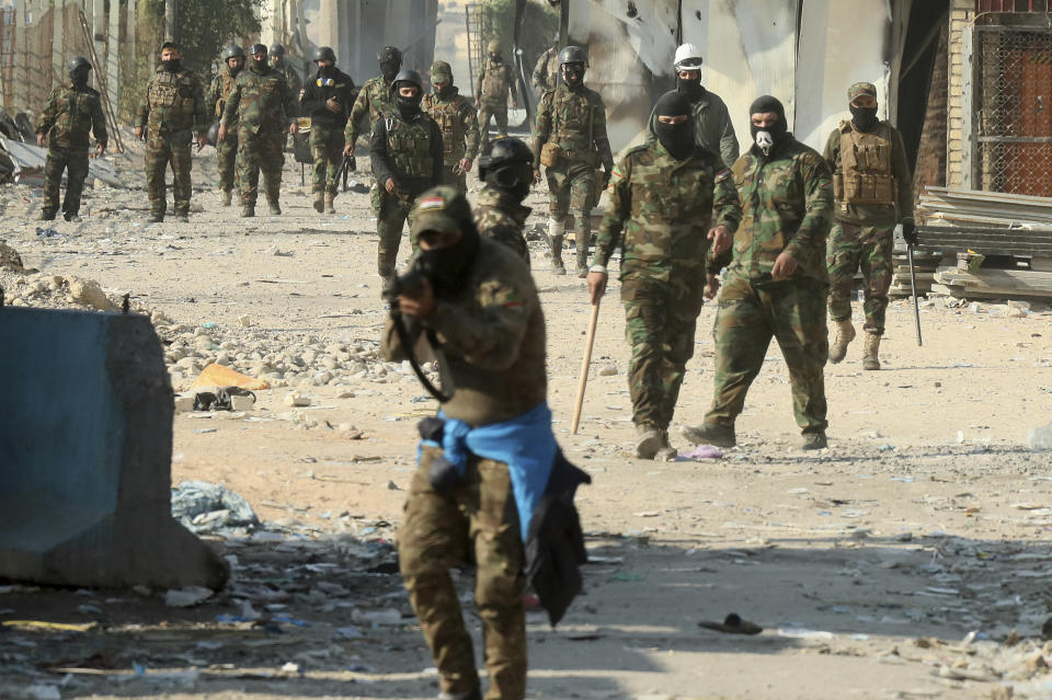 Security forces try to disperse anti-government protesters during clashes in Baghdad, Iraq, Saturday, Nov. 30, 2019. (AP Photo/Hadi Mizban)