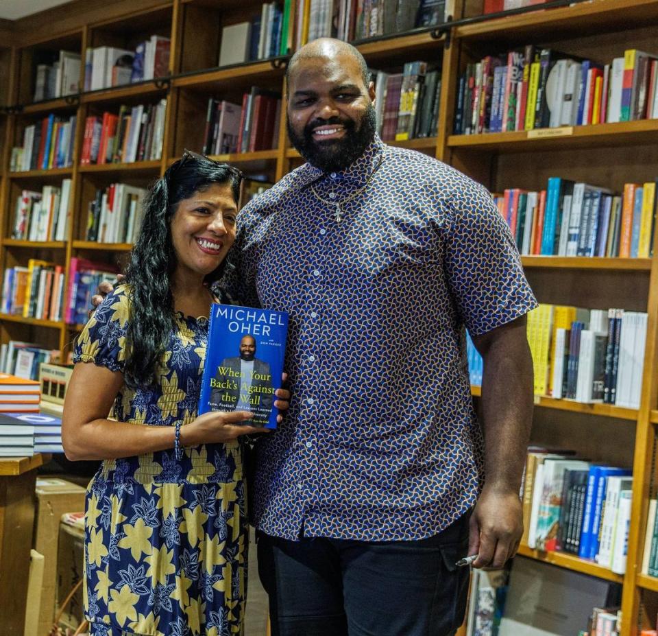 Author Michael Oher poses with Margarita Franco, after autographing his book titled “ When Your Back’s Against the Wall: Fame, Football, and Lessons Learned through a Lifetime of Adversity” to her at Books & Books in Coral Gables on Wednesday, August 23, 2023.