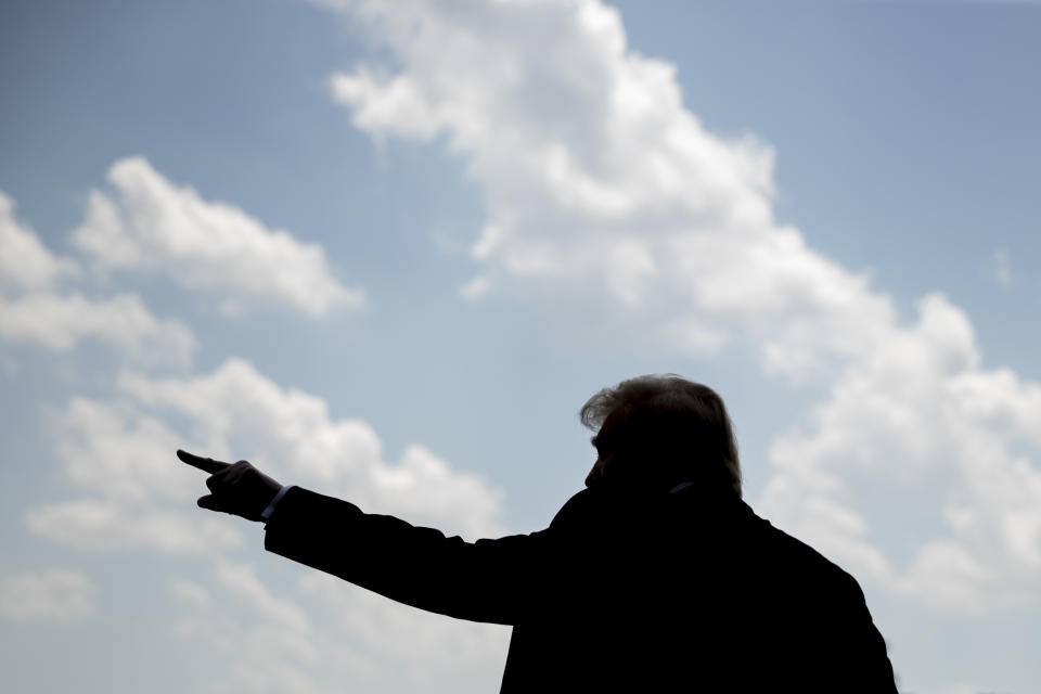 FILE - In this July 27, 2020, file photo President Donald Trump waves as he walks towards Marine One on the South Lawn of the White House in Washington. Trump is painting a dystopian portrait of what Joe Biden’s America might look like, asserting crime and chaos would ravage communities should the former vice president win the White House in November. Left unmentioned by Trump is that a recent surge in violent crime recently endured in several big American cities has come under his watch. (AP Photo/Andrew Harnik, File)