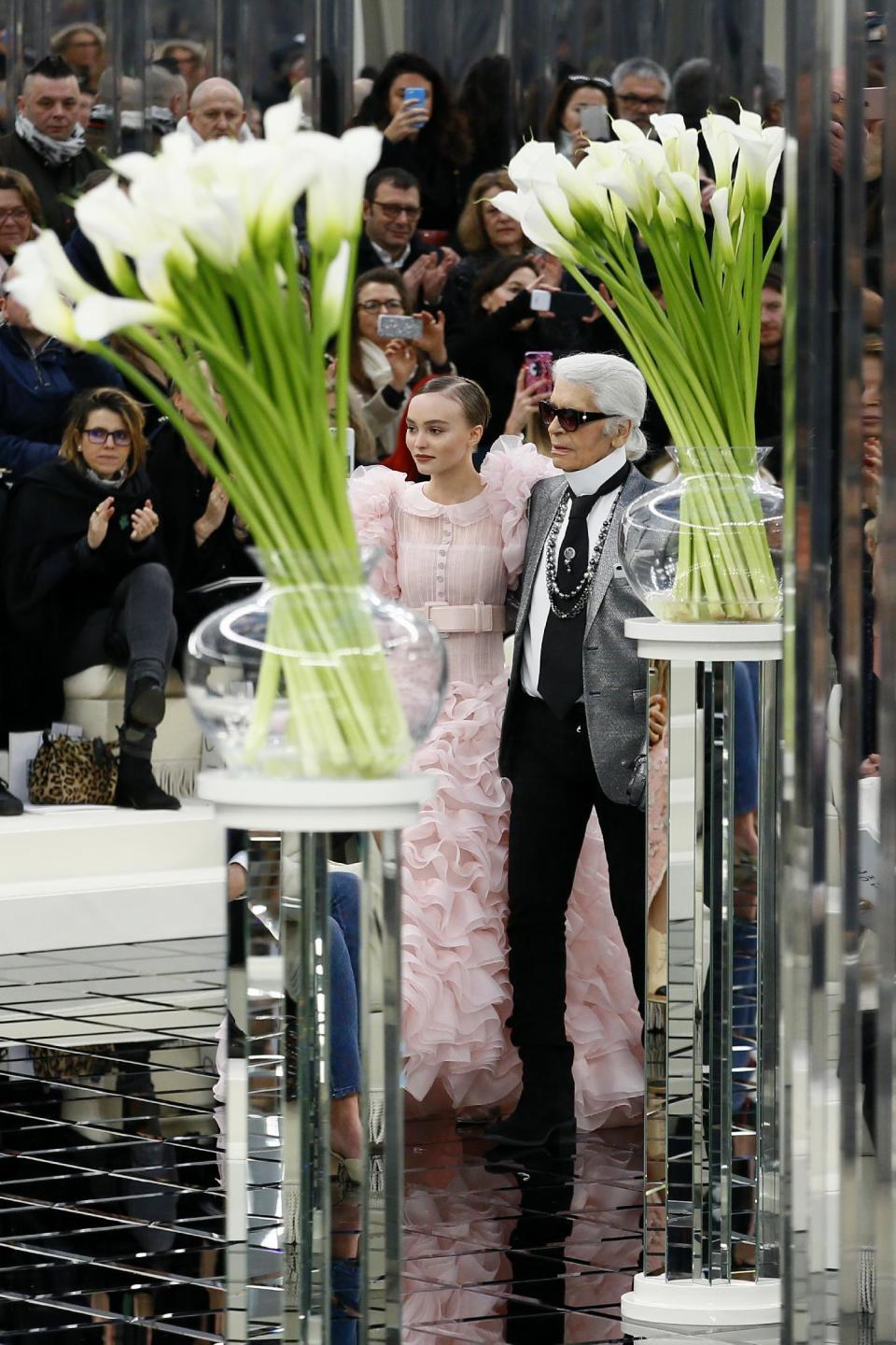 Lily-Rose Depp models with German fashion designer Karl Lagerfeld during Chanel Haute Couture Spring-Summer 2017 fashion collection presented in Paris, Tuesday, Jan.24, 2017. (AP Photo/Francois Mori)