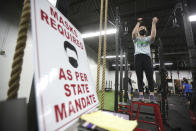 FILE - In this Dec. 10, 2020, file photo, Ainsley O'Donnell, 15, of Moscow, Pa., works out in preparation for softball season at NEPA Fit Club in Blakely, Pa. Irritated by the sweeping use of executive orders during the COVID-19 crisis, state lawmakers around the U.S. are moving to curb the authority of governors and top health officials to impose emergency restrictions such as mask rules and business shutdowns. (Jake Danna Stevens/The Times-Tribune via AP, File)