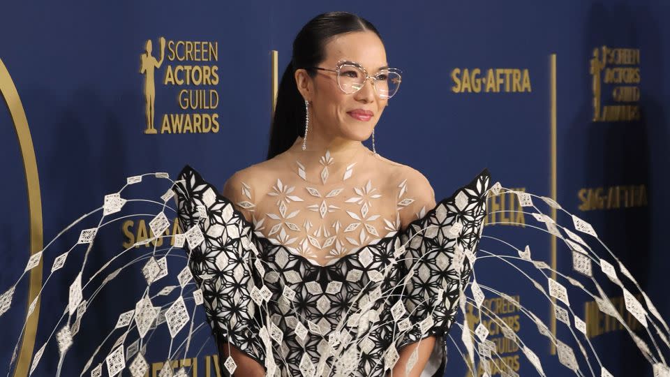 Ali Wong, wearing an ornately-patterned, chandelier-esque gown by Iris van Herpen. - Kevin Mazur/Getty Images