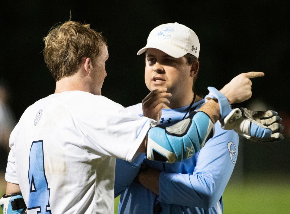 Christ Church's coach Joe Cummings talks to Christ Church's Camp Williams (4) during the game at J.L. Mann High School Thursday, April 11, 2019.