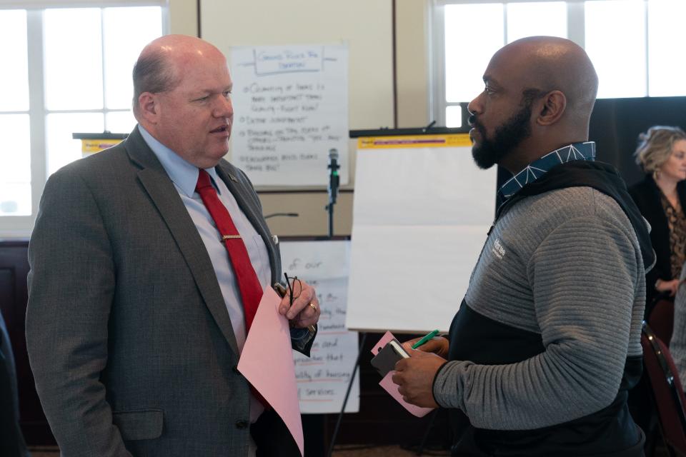 Shawnee County Commissioner Kevin Cook, left, chats with Topeka City Councilmember Marcus Miller, right, during Wednesday's homeless workshop at the Great Overland Station.