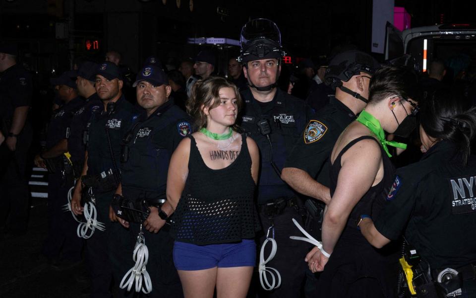 NYPD officers arrest several abortion rights activists after they blocked traffic while protesting the overturning of Roe v Wade - AFP