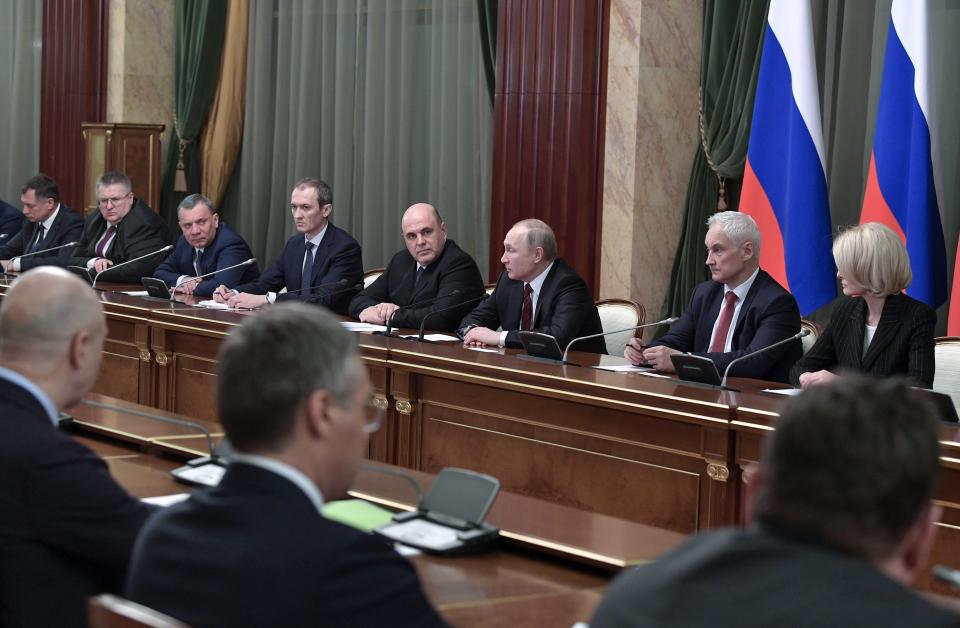 Russian President Vladimir Putin, center right, and new Russian Prime Minister Mikhail Mishustin, center left, attend a new cabinet meeting in Moscow, Russia, Tuesday, Jan. 21, 2020. Putin formed his new Cabinet Tuesday, replacing many of its members but keeping his foreign, defense and finance ministers in place. (Alexei Nikolsky, Sputnik, Kremlin Pool Photo via AP)