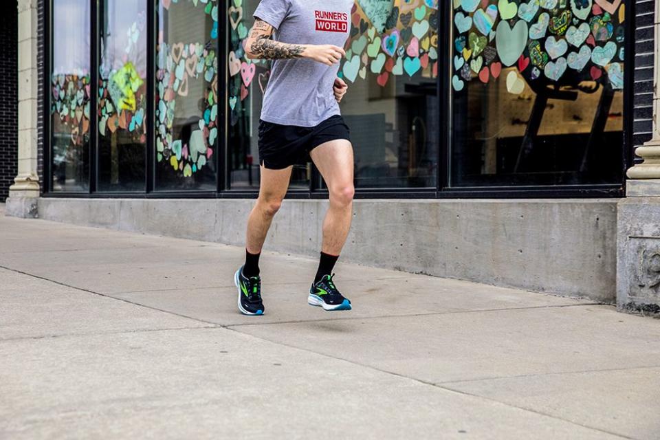 a man running on a sidewalk