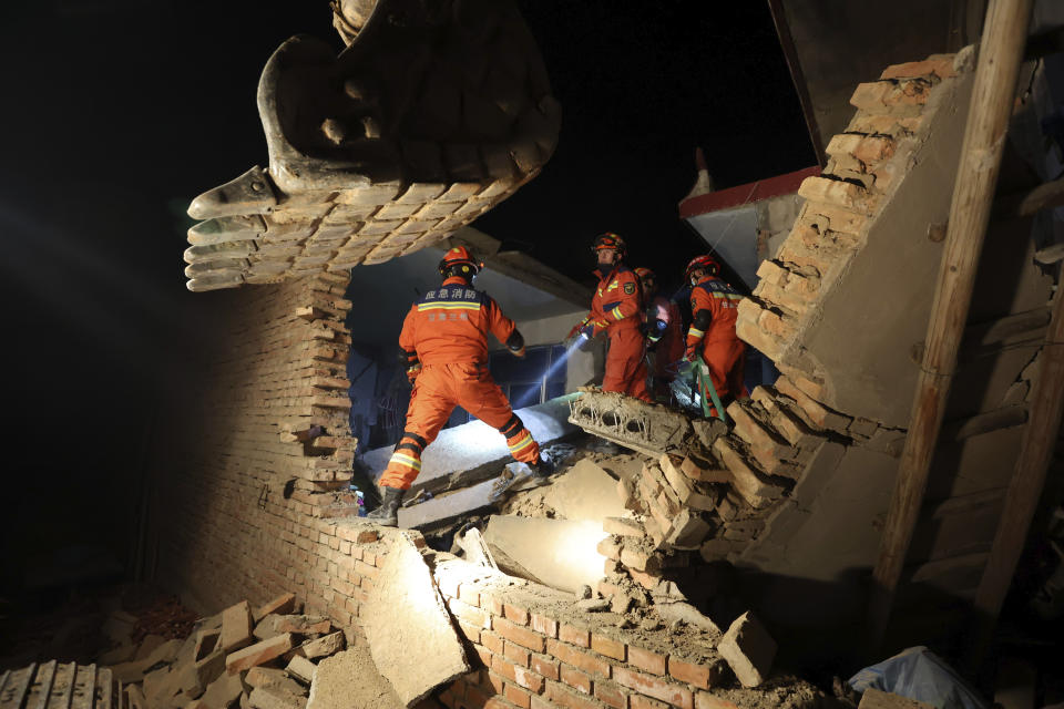 Rescuers work on the rubble of a house that collapsed in the earthquake in Kangdiao village of Jishishan county in northwestern China's Gansu province Tuesday, Dec. 19, 2023. An overnight earthquake killed multiple people in a cold and mountainous region in northwestern China, the country's state media reported Tuesday.(Chinatopix via AP)