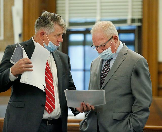 Special prosecutor Daniel Bennett, left, and defense attorney Kevin Reddington go over evidence before jury selection in the trial of Matthew Potter in Norfolk Superior Court in Dedham on Monday, Oct. 25, 2021. Potter is charged with manslaughter in the death of Chris McCallum during a fight at a Squantum club in 2019.