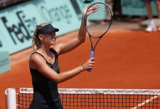 Russia's Maria Sharapova thanks the crowd after beating Romania's Alexandra Cadantu during French Open first round match at Roland Garros in Paris. Sharapova took just 48 minutes to race into the second round on Tuesday with a 6-0, 6-0 humiliation of Cadantu