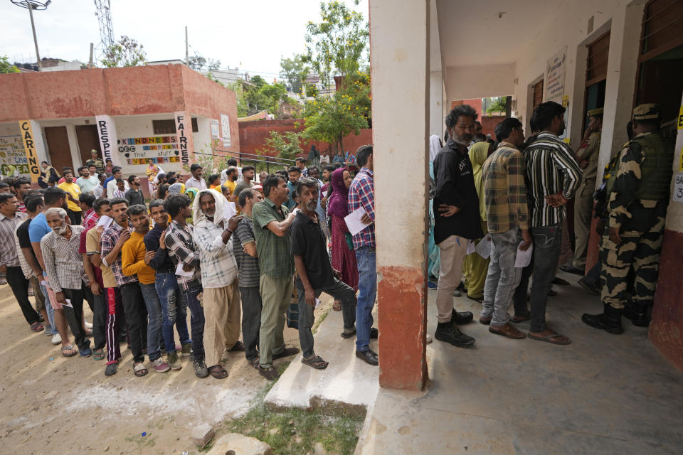 People queue up to vote during the second round of voting in the six-week-long national election in Jammu, India, Friday, April 26, 2024. (AP Photo/Channi Anand)