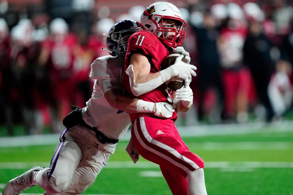Thomas Bussanich, of Westwood, fights off Daniel Cook, of Rumson-Fair Haven, before landing in the end zone, during overtime, Monday, November 27, 2023. Westwood went on to win the NJSIAA Group 2 Championship at SHI Stadium, 21-20, against Rumson-Fair Haven.