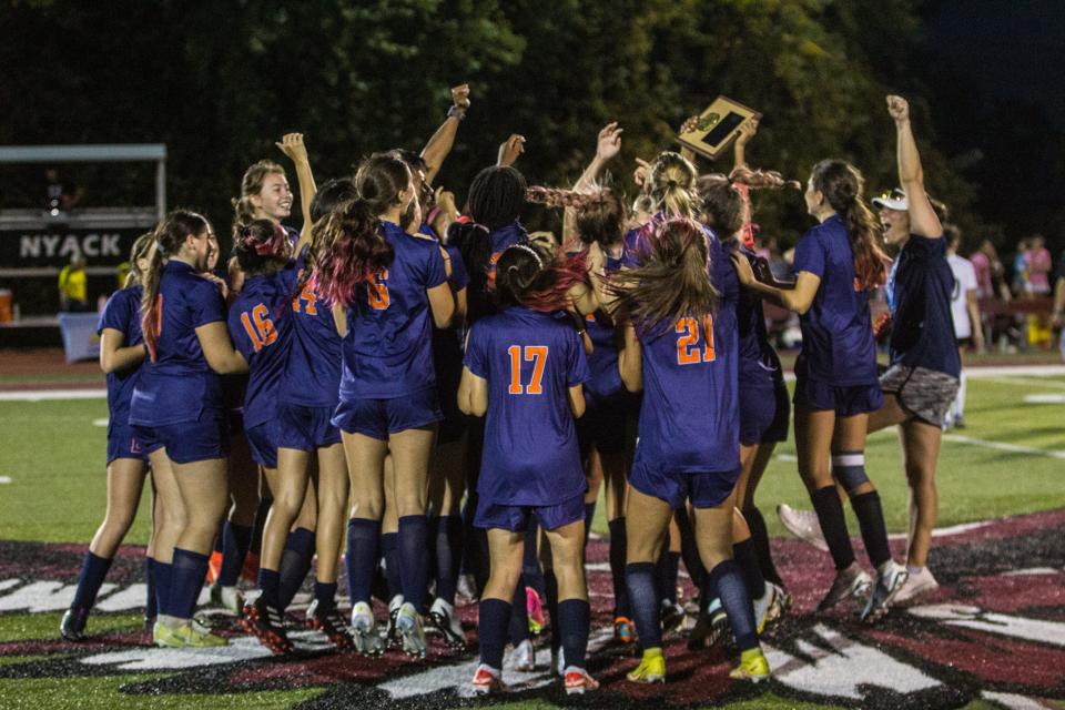 Briarcliff lifts up the championship plaque after defeating Croton-Harmon in double-overtime, 2-1, during the Section 1 Class B finals at Nyack High School on Oct. 28, 2023. It was the first time the Bears won a section title since 2009.