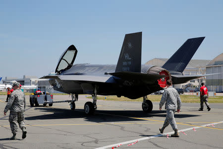 FILE PHOTO: U.S. airmen walk next to a Lockheed Martin F-35 Lightning II aircraft, as it is moved, on the eve of the 52nd Paris Air Show at Le Bourget Airport near Paris, France June 18, 2017. REUTERS/Pascal Rossignol