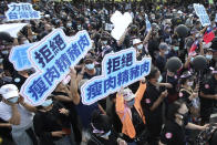 People hold up signs that read: "Anti-poisoned pork" during a protest in Taipei, Taiwan, Sunday, Nov. 22. 2020. Thousands of people marched in streets on Sunday demanding the reversal of a decision to allow U.S. pork imports into Taiwan, alleging food safety issues. (AP Photo/Chiang Ying-ying)