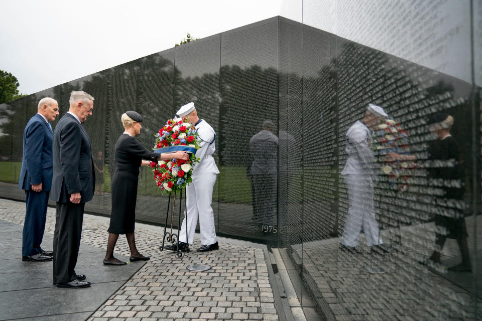 Cindy McCain, wife of, Sen. John McCain, R-Ariz., accompanied by President Donald Trump's Chief of Staff John Kelly, left, and Defense Secretary Jim Mattis, second from left, lays a wreath at the Vietnam Veterans Memorial in Washington, during a funeral procession to carry the casket of her husband from the U.S. Capitol to National Cathedral for a Memorial Service in Washington, DC on Sept. 1, 2018.