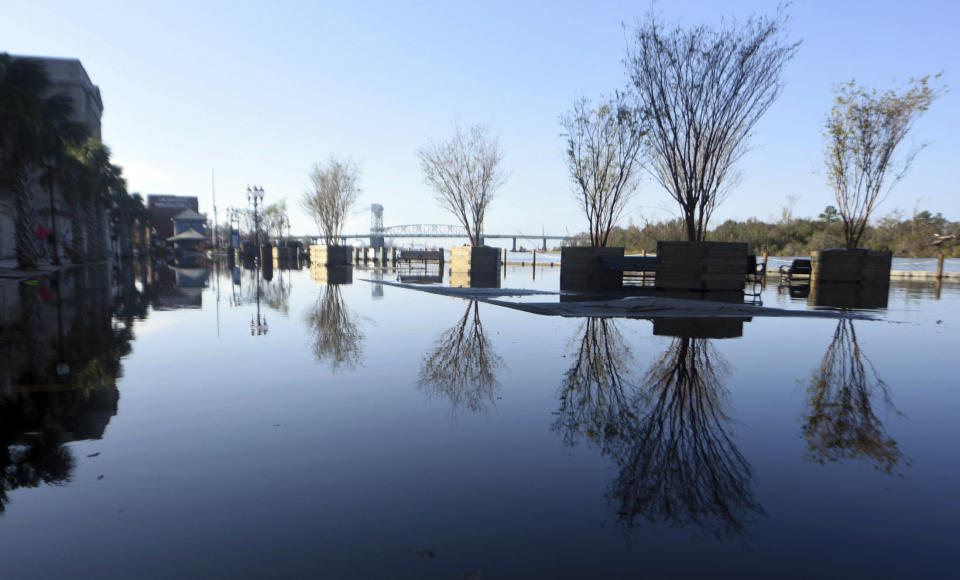 Floodwaters from the Cape Fear River cover Water St. in downtown Wilmington, N.C., Sunday, Sept. 23, 2018. (Matt Born/The Star-News via AP)