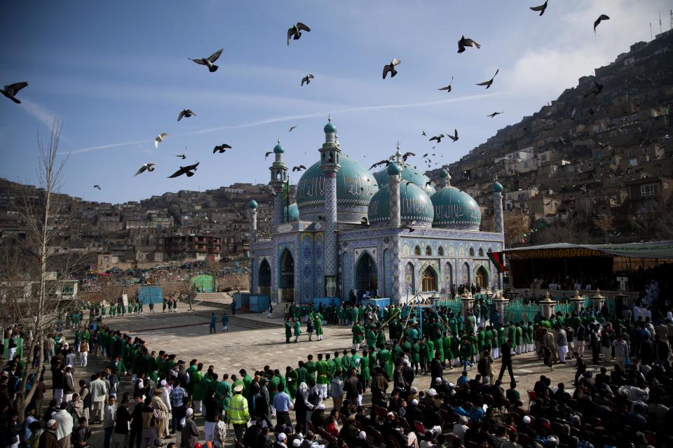 FILE - In this Thursday, March 21, 2013 file photo made by Associated Press photographer Anja Niedringhaus, hundreds of Afghans wait to see the holy flag at the Kart-e Sakhi mosque in Kabul, Afghanistan. Niedringhaus, 48, an internationally acclaimed German photographer, was killed and an AP reporter was wounded on Friday, April 4, 2014 when an Afghan policeman opened fire while they were sitting in their car in eastern Afghanistan. (AP Photo/Anja Niedringhaus, File)