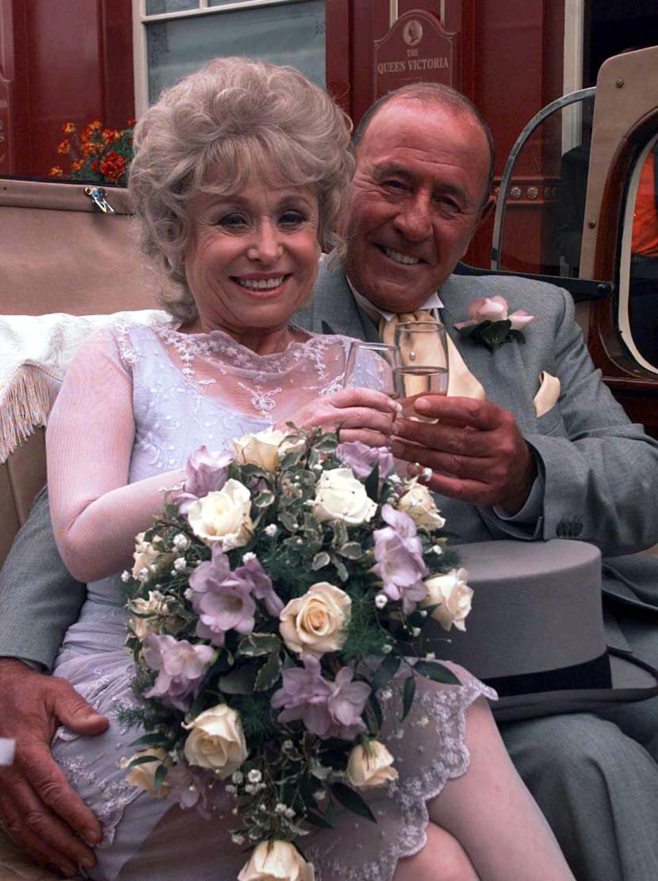 EastEnders stars Barbara Windsor and  Mike Reid, as Peggy Mitchell and Frank Butcher, during a photocall at London's Elstree studios, where  their on-screen wedding reception was filmed.   (Photo by John Stillwell - PA Images/PA Images via Getty Images)