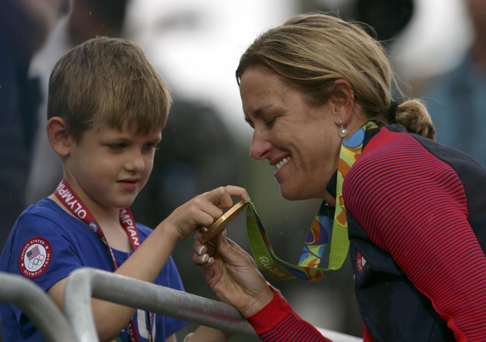 <p>Kristin Armstrong (USA) of USA with her son. REUTERS/Matthew Childs </p>