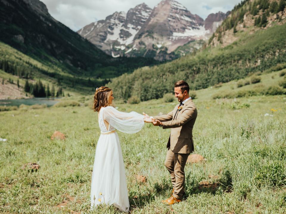abi and her husband doing their first look for their wedding in maroon bells amphitheater