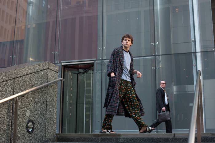 The Social Network: A man in pajamas stands at the top of a set of stairs