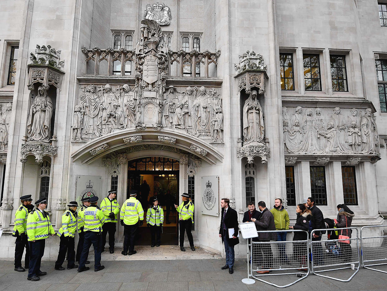 Police officers stand guard outside the Supreme court in London on the second day of a four-day hearing: Getty