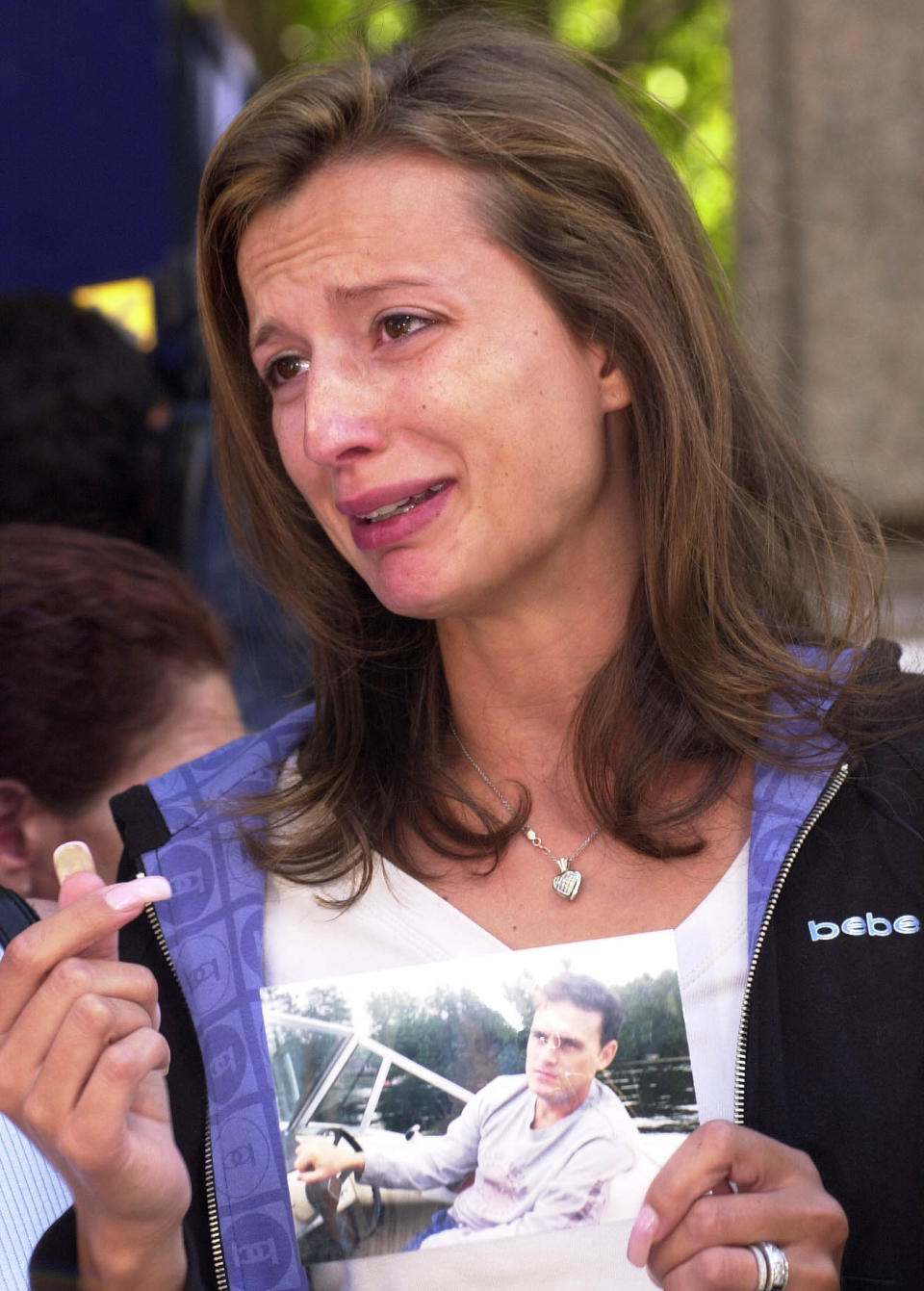 New York City--The pain is etched on Monica Iken's face as she holds pix of her husband Michael Iken (Dale Brazao / Toronto Star via Getty Images)