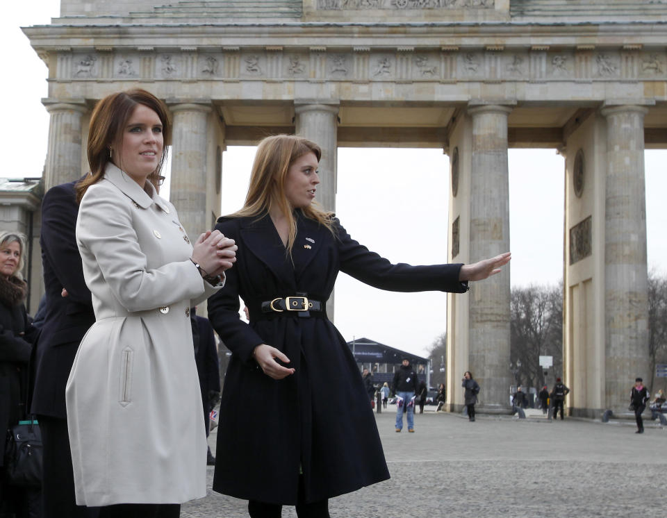 Members of the British royal family, Princess Beatrice of York, right, and Princess Eugenie of York, left, arrive for a promotion event for the Great Britain MINI Tour 2013 at the Brandenburg Gate in Berlin, Germany, Thursday, Jan. 17, 2013. It was meant to be a Mini adventure that nearly became a major embarrassment.Two British royals on a mission to promote their country broke German road rules by running a red light near Berlin's iconic Brandenburg Gate. With photographers and police in tow, Princess Eugenie and her older sister Princess Beatrice then took a swift right into the safety of the British embassy compound. At least the 22 and 24-year-old sisters didn't have to decide which side of the road to drive on. The entire 500-meter (550-yard) staged tour was along one-way streets. (AP Photo/Michael Sohn)