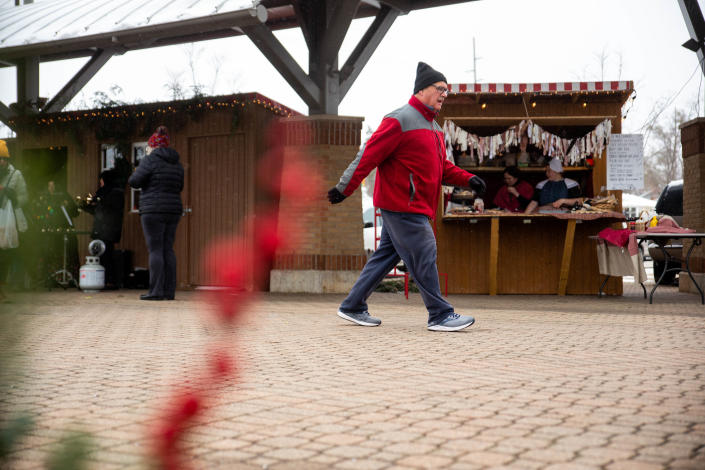 Shoppers stroll past vendors during the first Kerstmarkt date in downtown Holland.