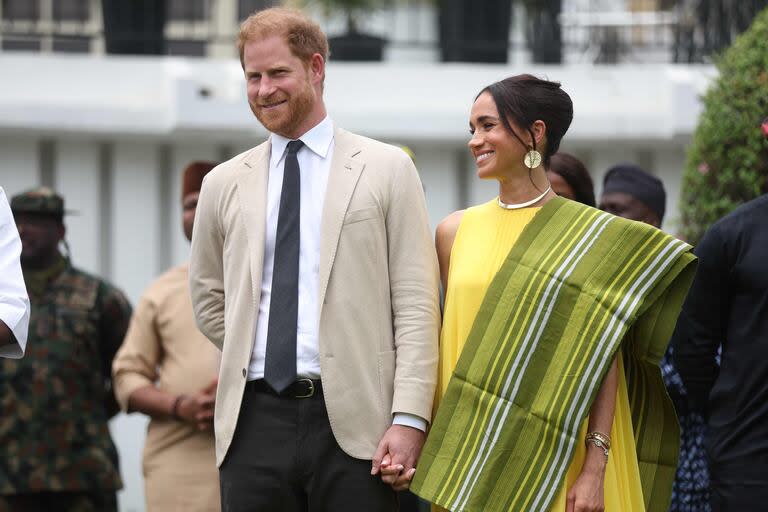 Britain's Prince Harry (2ndR), Duke of Sussex, and  Britain's Meghan (R), Duchess of Sussex, react as Lagos State Governor, Babajide Sanwo-Olu (unseen), gives a speech at the State Governor House in Lagos on May 12, 2024 as they visit Nigeria as part of celebrations of Invictus Games anniversary. (Photo by Kola SULAIMON / AFP)