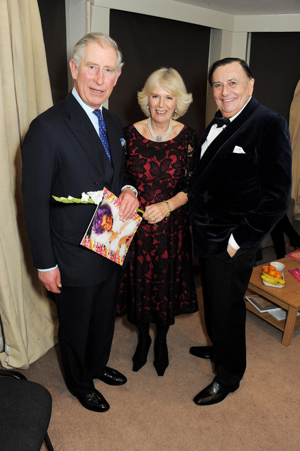 King Charles and Camilla pose with Barry Humphries