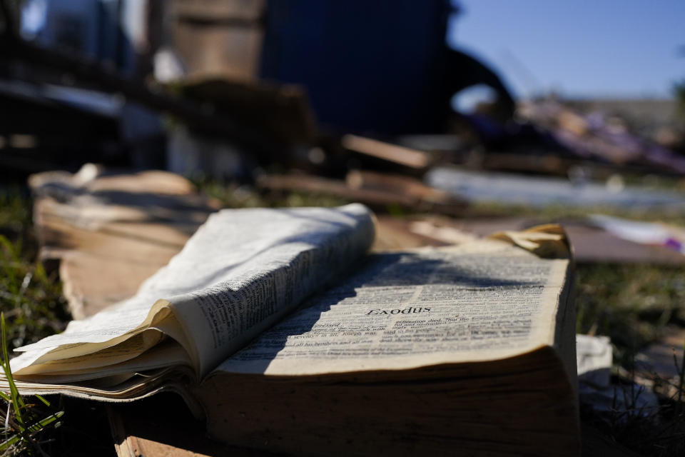 A Bible rests on the lawn of Community Baptist Church amongst storm debris Monday, Dec. 11, 2023, in Nashville, Tenn. The church was destroyed when severe storms came through over the weekend. Members of the church were trapped and injured inside the building during the storm on Saturday. (AP Photo/George Walker IV)