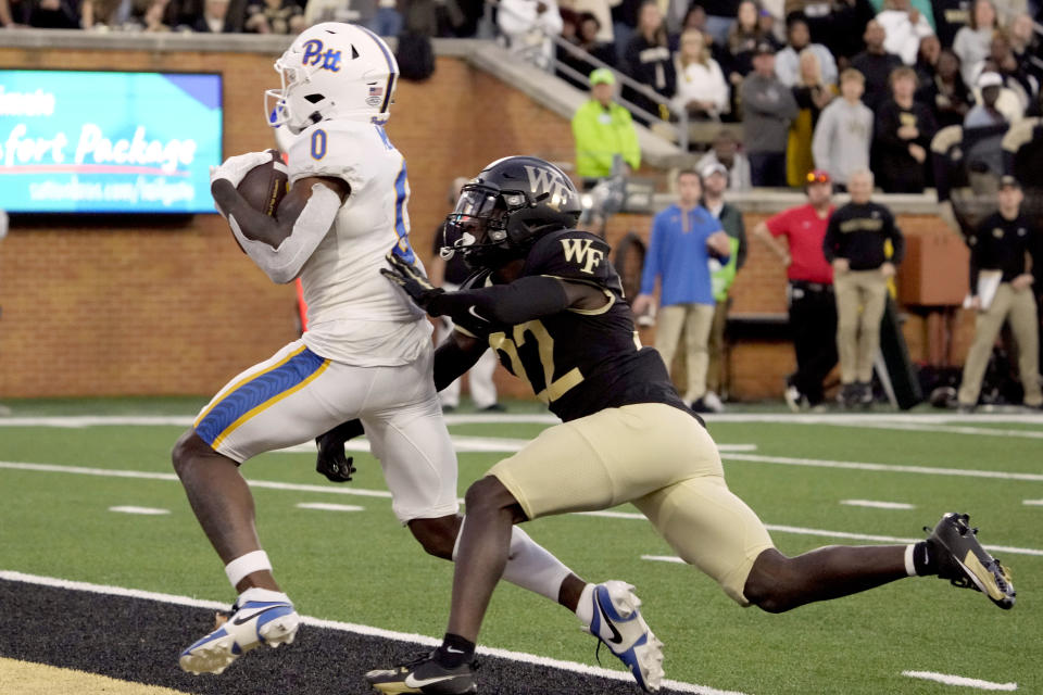 Pittsburgh wide receiver Bub Means (0) catches a touchdown pass against Wake Forest defensive back Demarcus Rankin (22) during the second half of an NCAA college football game in Winston-Salem, N.C., Saturday, Oct. 21, 2023. (AP Photo/Chuck Burton)