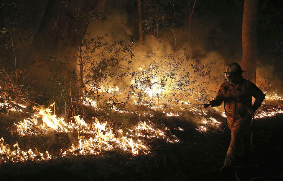 Firefighters control flames during hazard reduction in Bilpin 75 kilometers (46 miles) from Sydney in Australia, Wednesday, Oct. 23, 2013. (AP Photo/Rob Griffith)