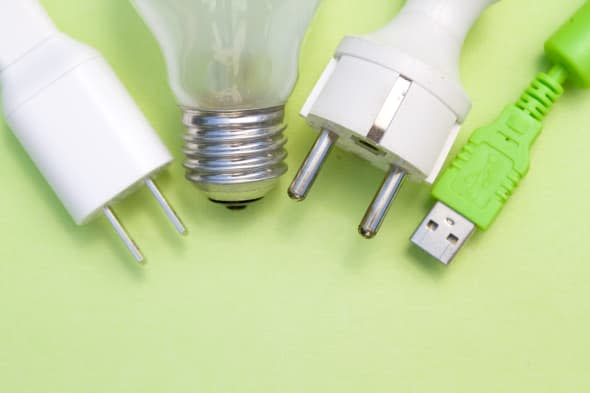 Series of items demanding electric energy USB plug, American electricity plug, European electricity plug and standard light bulb