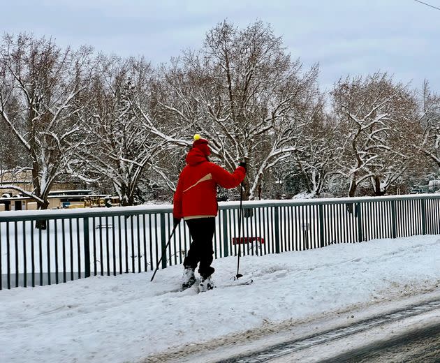 A pedestrian uses cross-country skis to navigate a sidewalk in Bellingham, Washington, early Tuesday morning.