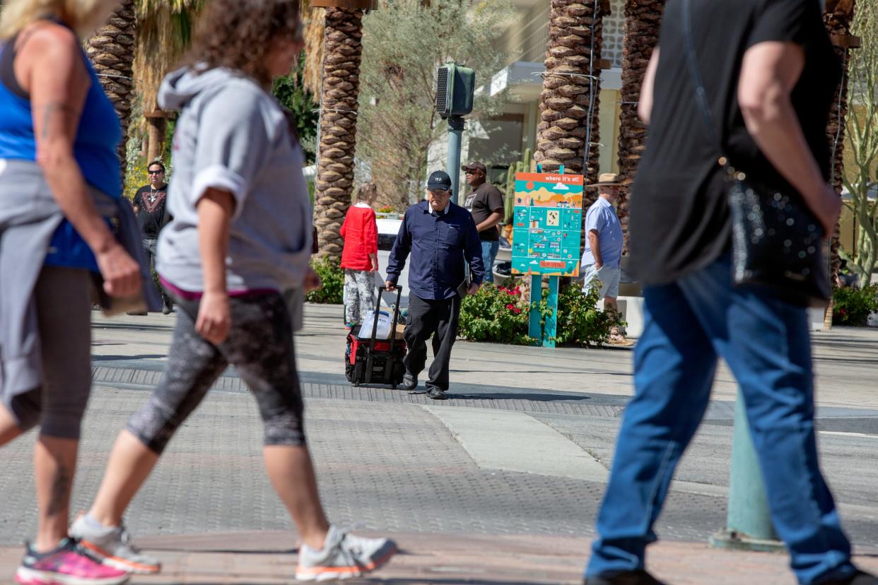 People walk along Palm Canyon Drive in downtown Palm Springs. The area is one of several in the city that is vulnerable to thieves targetting retail stores.