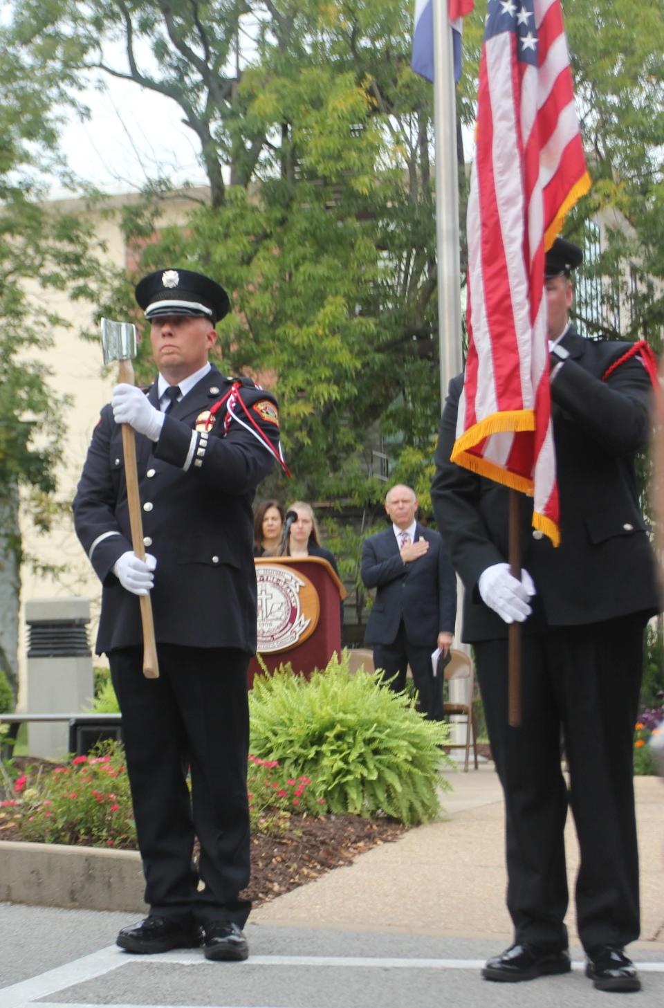 Matt Eaves, a Branson Fire and Rescue engineer, holds an axe as he pays tribute during a 9/11 memorial ceremony on Monday at the College of the Ozarks.