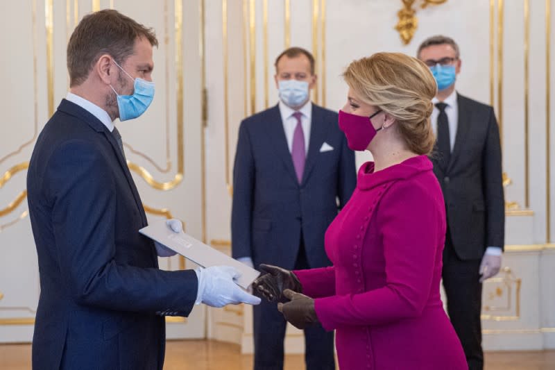 Slovakia's President Zuzana Caputova and Prime Minister Igor Matovic wearing protective face masks attend the cabinet's inauguration at Presidential Palace in Bratislava