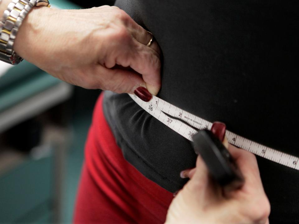 FILE - In this Jan. 20, 2010 file photo, a subject's waist is measured during an obesity prevention study in Chicago. According to a Centers for Disease Control and Prevention study released on Thursday, Feb. 27, 2020, the U.S. obesity rate continues to rise, with an especially large jump in the ranks of people who are severely obese. (AP Photo/M. Spencer Green, File)