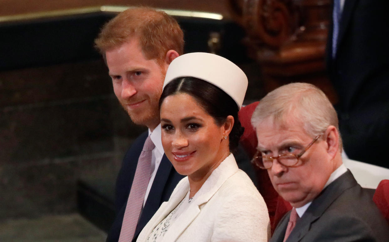 (L-R) Britain's Prince Harry, Duke of Sussex, Britain's Meghan, Duchess of Sussex and Britain's Prince Andrew, Duke of York, are seated as they attend the Commonwealth Day service at Westminster Abbey in London on March 11, 2019. - Britain's Queen Elizabeth II has been the Head of the Commonwealth throughout her reign. Organised by the Royal Commonwealth Society, the Service is the largest annual inter-faith gathering in the United Kingdom. (Photo by Kirsty Wigglesworth / POOL / AFP)        (Photo credit should read KIRSTY WIGGLESWORTH/AFP/Getty Images)