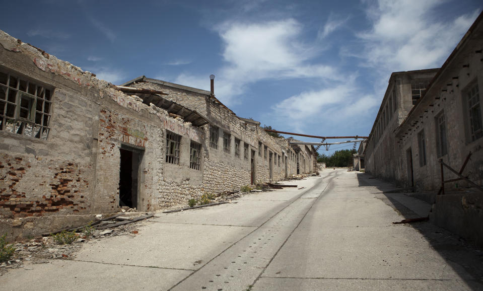 In this photo taken June 28, 2012, ruined prison buildings are seen at the Adriatic island of Goli Otok. The prison island housed up to 16,000 political prisoners over an eight-year period. They ended up there after being accused by Tito's regime of expressing sympathy toward Josef Stalin and his hardline Soviet dictatorship. (AP Photo/Darko Bandic)