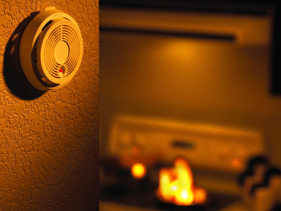 smoke alarm in a kitchen with flames on the stove