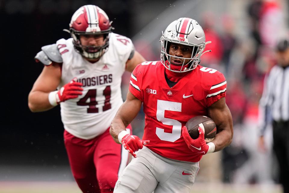 Nov 12, 2022; Columbus, Ohio, USA;  Ohio State Buckeyes running back Dallan Hayden (5) runs past Indiana Hoosiers defensive lineman Beau Robbins (41) during the second half of the NCAA football game at Ohio Stadium. Ohio State won 56-14. Mandatory Credit: Adam Cairns-The Columbus Dispatch