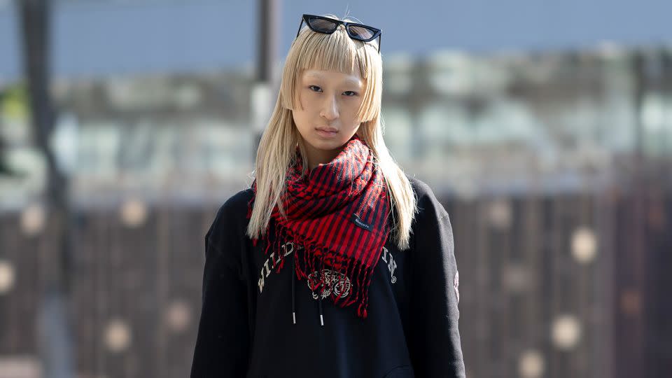 Outside Meagratia’s show, Amo, who only disclosed her first name, is seen wearing a hoodie and boots by fashion designer Bill Whitten. - Justin Shin/Getty Images