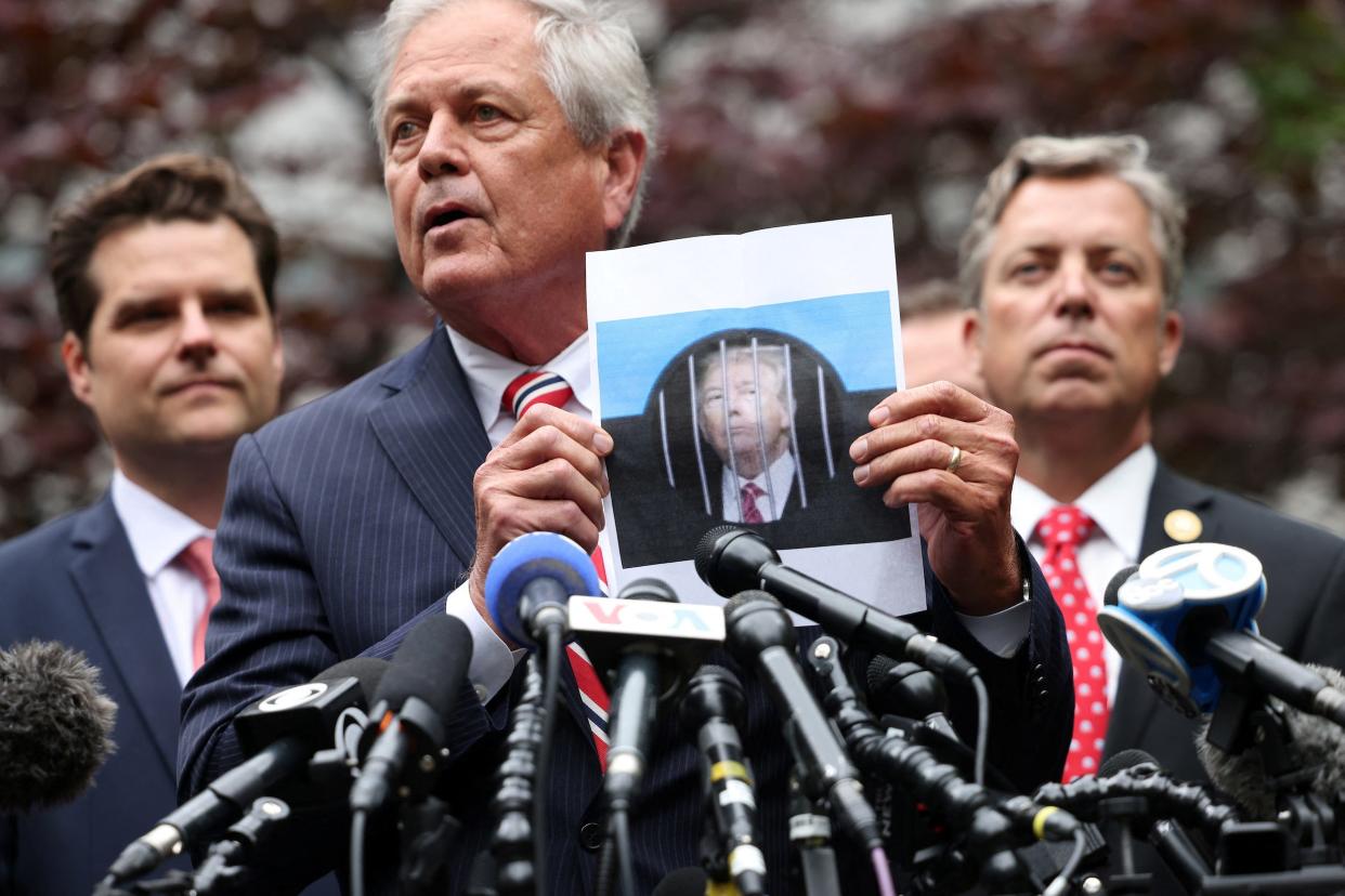 Ralph Norman holds up an image of Donald Trump behind bars