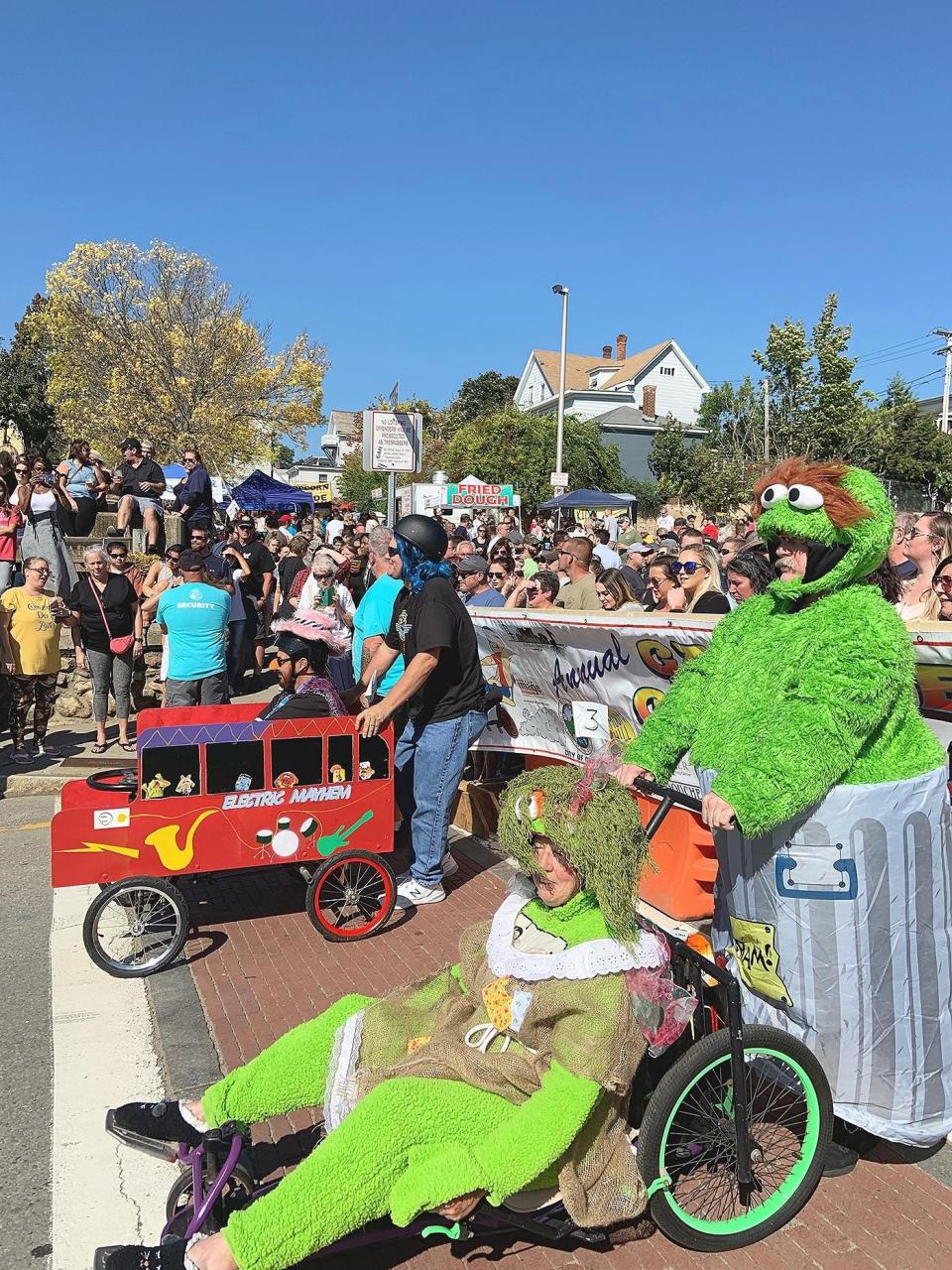 Team Trashy and Electric Mayhem wait at the starting line during last year's Chair Luge event in Gardner, part of the Gardner Ale House Oktoberfest Party in the Street festivities.