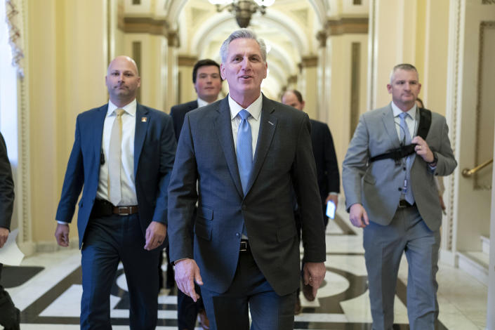 Speaker of the House Kevin McCarthy, R-Calif., talks to reporters as he walks to the speaker's ceremonial office at the Capitol in Washington, Monday, Jan. 9, 2023. (AP Photo/Jose Luis Magana)