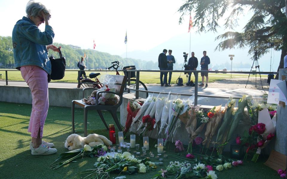 People lay flowers in a park where children were stabbed - Peter Byrne/PA